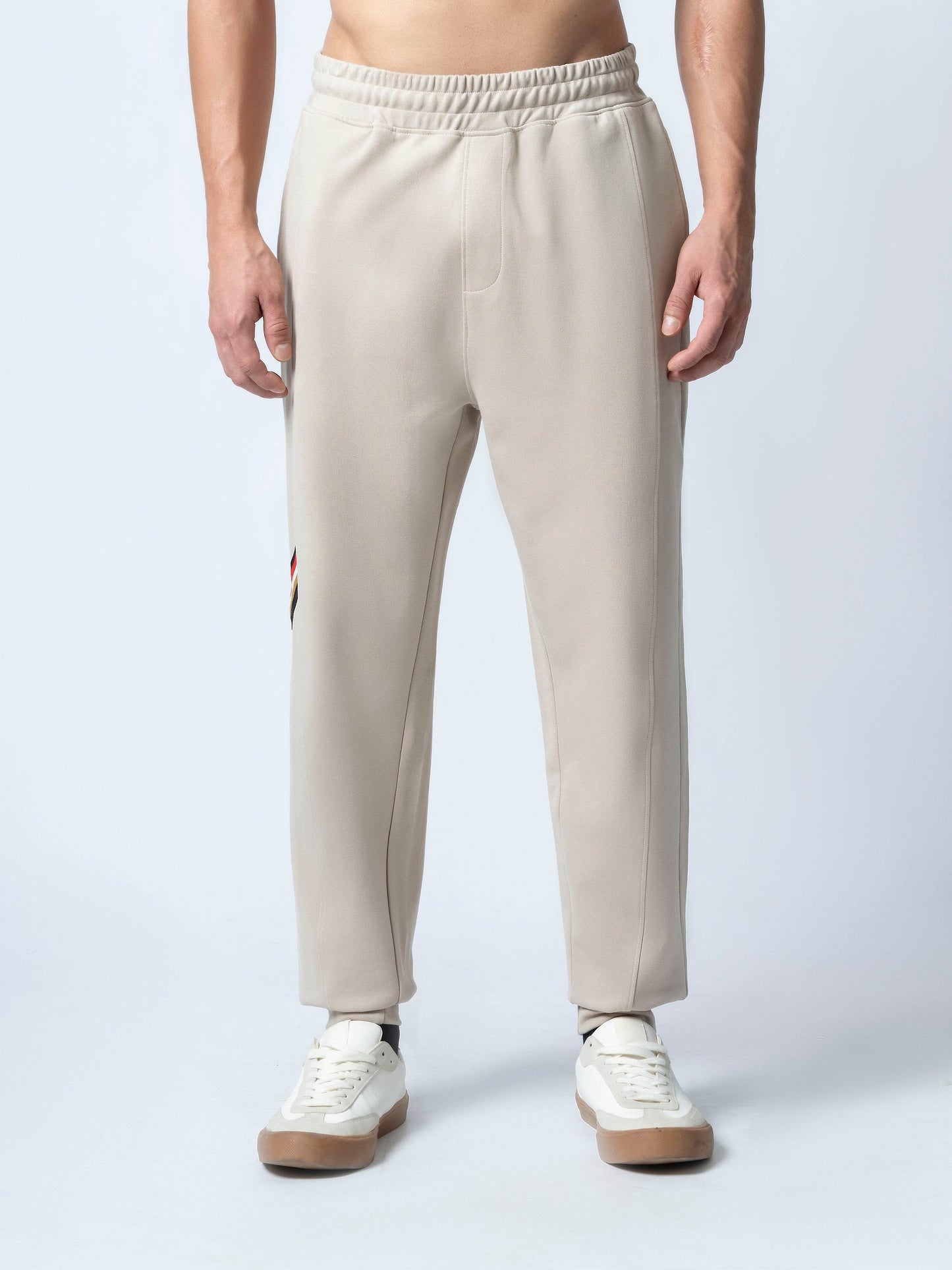 Rougen Cotton Poly Elastane Interlock Jogger with Cut-and-Sew Design and 4-Color Flag Tape Sand - ENGYNE